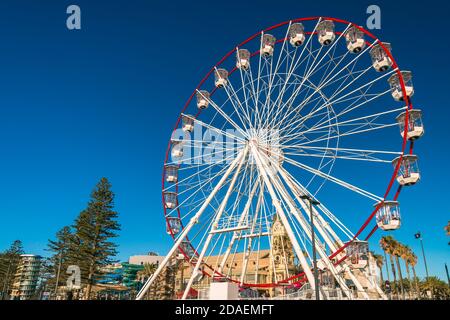 Adelaide, South Australia - January 12, 2019: Glenelg Mix102.3 Giant Ferris Wheel viewed from the Moseley Square on a bright summer day Stock Photo