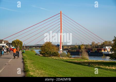 Rhine bank path at Fleher Bridge, in Düsseldorf Flehe, over the Rhine, motorway bridge of the A46, highest bridge pylon in Germany, cable-stayed bridg Stock Photo