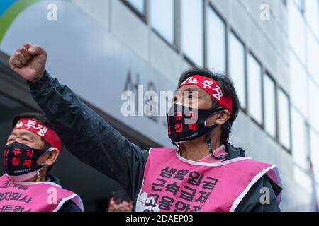 Seoul, South Korea. 12th Nov, 2020. Protesters of Korean Railway Workers' Union wearing face masks raise their fists during a rally against KORAIL(Korea Railroad Corporation).Korean Railway Workers' Union members stage a rally against KORAIL (Korea Railroad Corporation) and the government's policy in front of Seoul Regional Employment and Labor Administration in Seoul. Credit: SOPA Images Limited/Alamy Live News Stock Photo