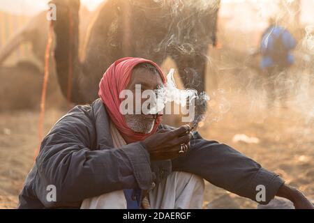 portrait of a man is smoking bidi at pushkar festival,india. Stock Photo