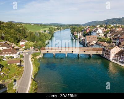 Aerial image the old wooden covered bridge over the Rhine river, which connects the Swiss old town Diessenhofen and German town Gailingen. Stock Photo