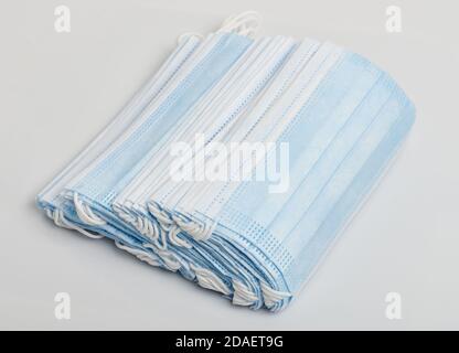 Pile of blue cotton face mask isolated on studio background Stock Photo