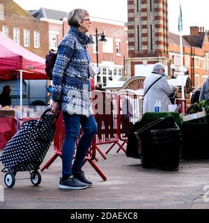 London UK, November 12 2020, Senior Woman Pulling Shopping Trolley Walking Alone During Coronavirus Lockdown Stock Photo