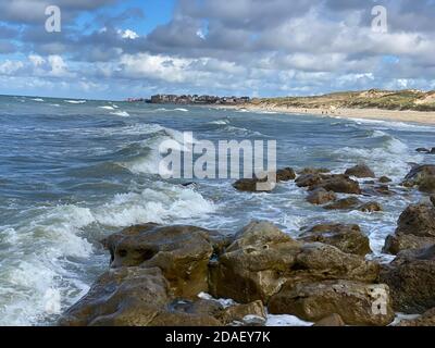 View of Ambleteuse in france over the waves breaking on the rocks Stock Photo