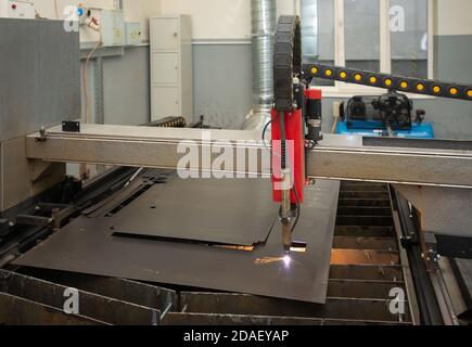 Industrial laser or plasma cutting processing manufacture technology of flat metal sheet. steel material with sparks Stock Photo