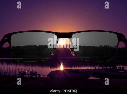 Looking through glasses to bleach sunset landscape. Color blindness at night. World perception during depression. Medical condition. Stock Photo