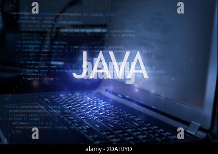 Java inscription against laptop and code background. Learn java programming language, computer courses, training. Stock Photo