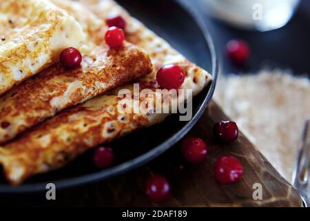 National Russian food. Pancakes in a frying pan with milk. Rustic stylization Stock Photo