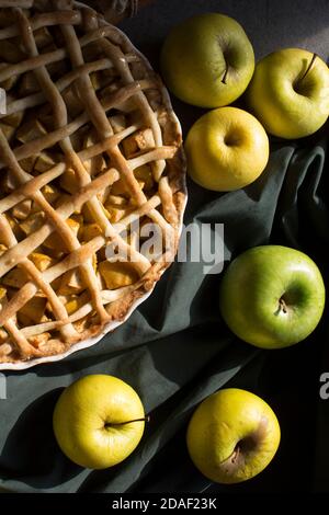 Apple pie with lattice decoration. Homemade dessert pie top view photo. Grey background. Stock Photo