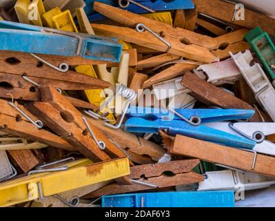 Pile of old plastic and wooden clothes pegs Stock Photo