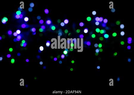 Multicolored spots of light against black background Stock Photo