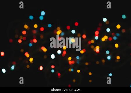 Multicolored spots of light against black background Stock Photo
