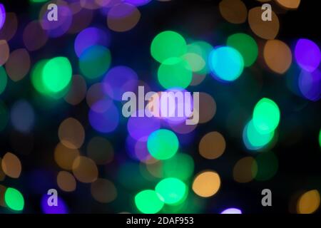 Multicolored spots of light against black background Stock Photo