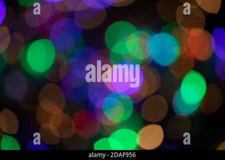 Multicolored spots of light against black background Stock Photo