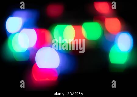 Multicolored spots of light against black background Stock Photo