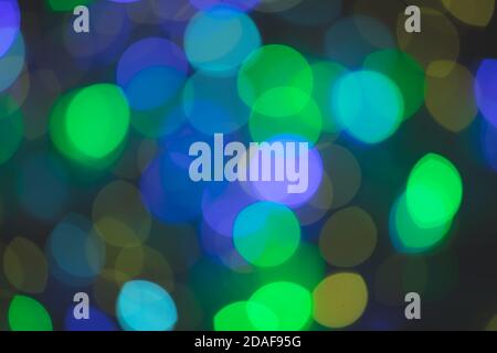 Multicolored spots of light against black background Stock Photo