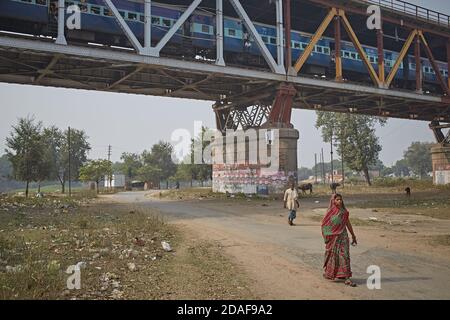 Varanasi, India, December 2015. People passing under a train bridge. Stock Photo