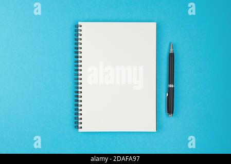 Ballpoint Pen and Blank Paper Notebook with Spiral Binding as Business Copy  Space on Yellow Background Stock Photo - Alamy