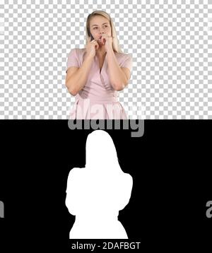 Blonde lady in pink making a call, Alpha Channel Stock Photo