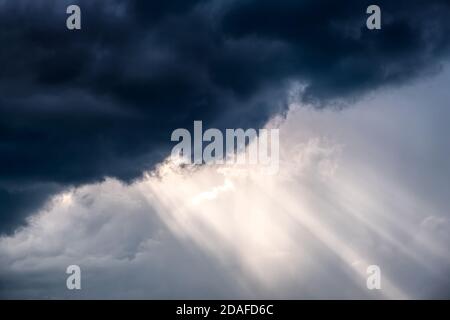 Light in the Dark and Dramatic Storm Clouds Stock Photo