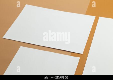 Blank paper poster brochure a4 size mockup template on beige background. Stock Photo