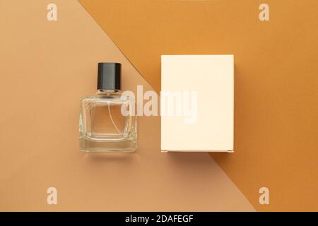 Perfume bottle and box mockup template on beige background. Stock Photo