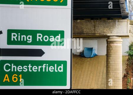 A pop-up tent pitched on Park Square roundabout, Sheffield under a Supertram bridge used by a homeless person sleeping rough Stock Photo