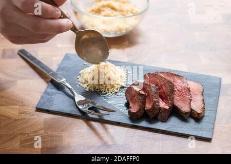 On Top Table Grilled picanha steak sliced and served on a rustic gray plate with ...