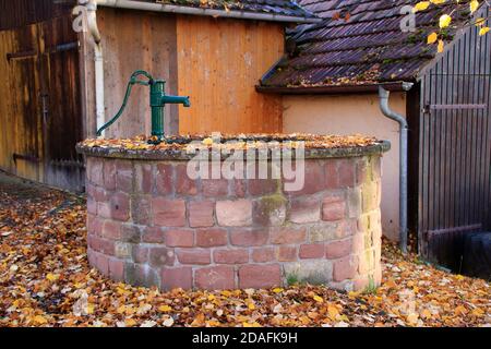Old brick well made of sandstone in gueltlingen Stock Photo