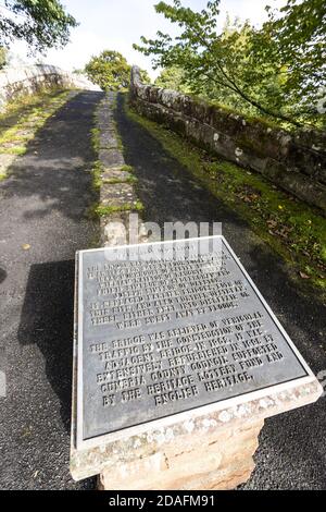 Interpretive history panel on Lanercost Old Bridge built of red sandstone over the River Irthing in 1724 at Lanercost, Cumbria UK Stock Photo