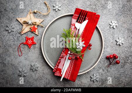 Christmas table setting with christmas decorations on gray background. Top view, copyspace. Stock Photo