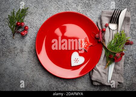 Christmas table setting with christmas decorations on gray background. Top view, copyspace. Stock Photo