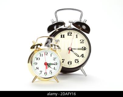 Two different alarm clocks isolated on a white background Stock Photo
