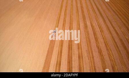 aerial view of tractor Plowing the field in sunny day Stock Photo