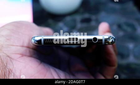 Close up usb charging port, Prise jack, speakers, microphone, on the bottom of a smartphone. Stock Photo