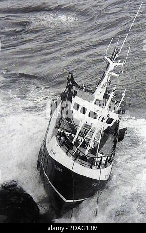 The Hull registered vessel SARB-J  (then still intact) ashore on rocks on the North Yorkshire coast near Whitby.  It came to grief when its propeller fouled its nets on the 20th January 1994. All crew were saved by helicopter.The fishing  trawler broke up but parts of the wreck are still visible (2020) at Bayness End  near Robin Hoods Bay (Yorkshire). Stock Photo