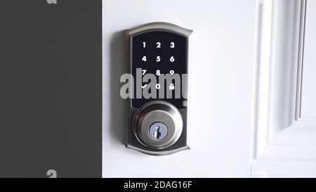 Digital smart door lock security system with the password, close up on numbers on the screen. Stock Photo