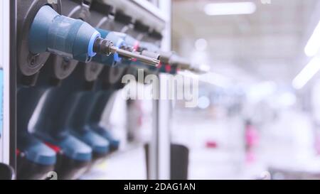 Selective focus close up on a set of electric powered screwdrivers with factory copy space background, cordless drill screw driver. Stock Photo