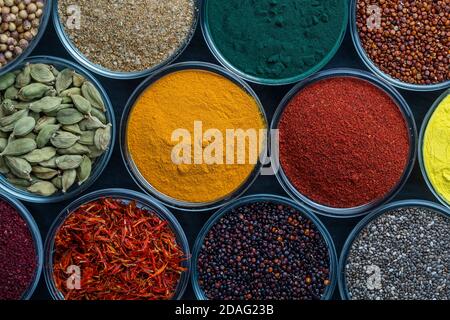 Different spices and herbs on background, close up, top view. Assortment colorful spices, seeds and herbs for cooking food Stock Photo
