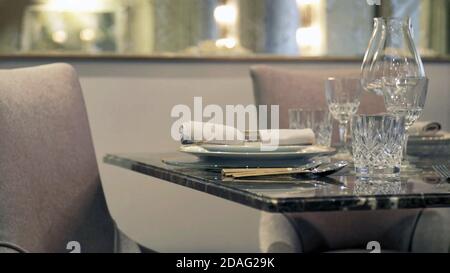 empty luxury and elegant Table with glasses and forks and knives in Luxurious Restaurant Stock Photo