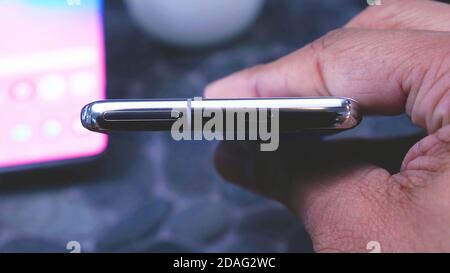 Slot sim and Micro SD memory card on top side of smartphone. Stock Photo
