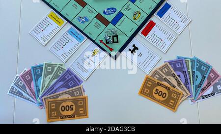 Orlando, FL/USA-12/20/19:  Pieces for the game Monopoly by Hasbro on a white background.  Concept business, banking, and property. Stock Photo