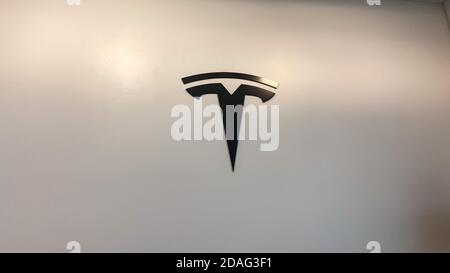 Orlando, FL/USA-2/17/20:  The Tesla logo on the wall at a Tesla retail store.  Tesla is an electric automobile company owned by Elon Musk. Stock Photo