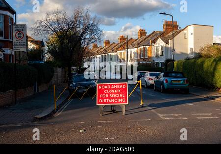 ‘Road ahead closed for social distancing’ traffic sign in a residential area of Balham, South London. Stock Photo