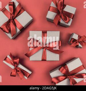 Gift boxes wrapped in craft paper with brown ribbons and bows. Festive monochrome flat lay. Stock Photo
