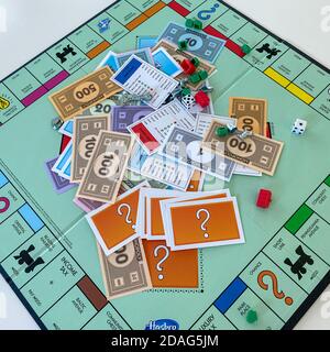 Orlando, FL/USA-12/20/19:  Pieces for the game Monopoly by Hasbro on a white background.  Concept business, banking, property, and game over. Stock Photo