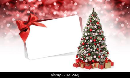 gift card with decorated christmas tree full of red and silver balls, decorations and wrapped  packages isolated on white and blurred lights backgroun Stock Photo