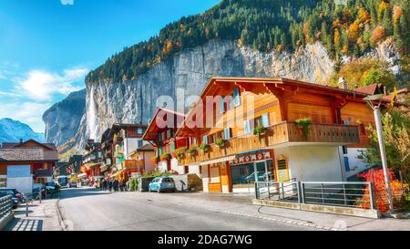 Fantastic autumn view of traditional swiss houses in Lauterbrunnen village. Picturesque Alpine village.  Location: Lauterbrunnen village, Berner Oberl Stock Photo