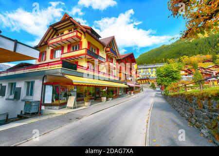 Fantastic autumn view of traditional swiss chalets in Wengen village. Picturesque Alpine village Wengen..  Location: Wengen village, Berner Oberland, Stock Photo