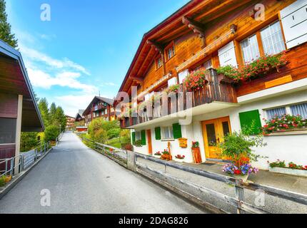 Fantastic autumn view of traditional swiss chalets in Wengen village. Picturesque Alpine village Wengen..  Location: Wengen village, Berner Oberland, Stock Photo